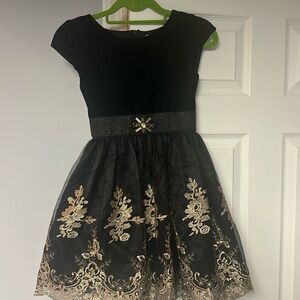 Gorgeous quality dressy dress in black with gold accents. Size 8